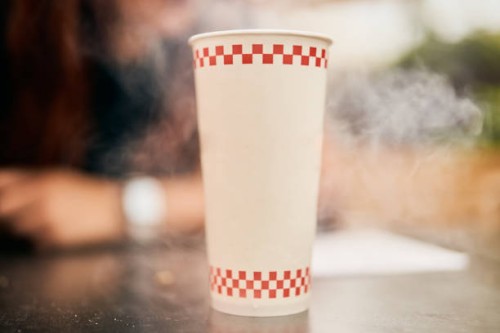 recyclable cardboard cup on a restaurant table - junk food stock pictures, royalty-free photos & images
