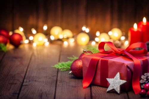 red christmas gift box on rustic wooden table - home decoration stock pictures, royalty-free photos & images