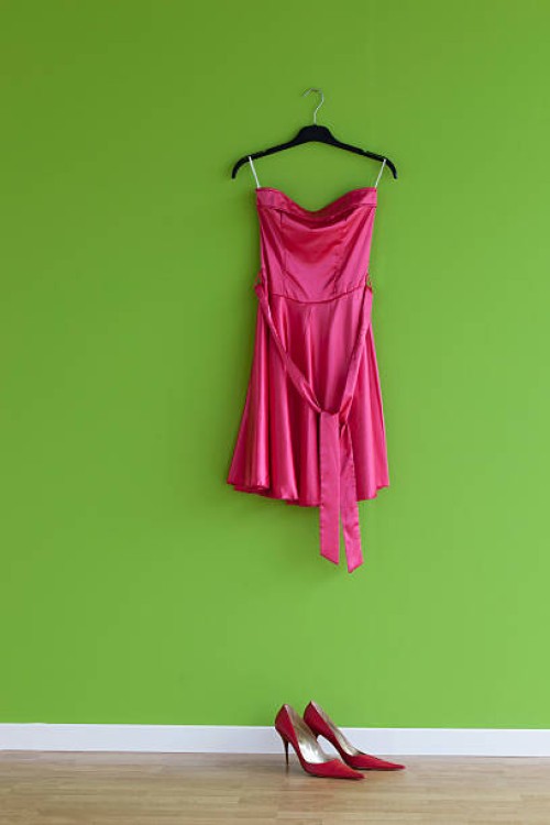 red suit and shoes against a green wall - fashion stock pictures, royalty-free photos & images