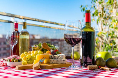 red wine bottle and glass and delicatessen on terrace table - food stock pictures, royalty-free photos & images