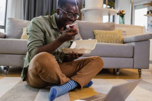 relaxed afternoon at home and consuming internet content - junk food stock pictures, royalty-free photos & images