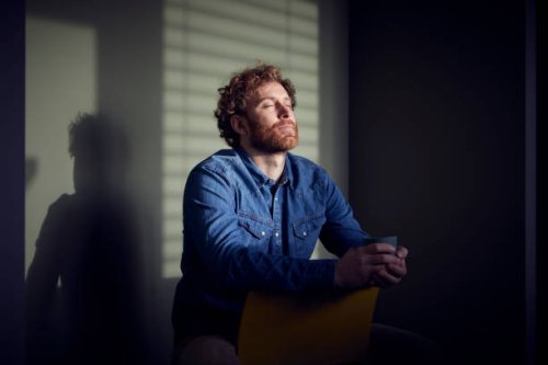 relaxed casual businessman sitting down with closed eyes - coffee stockfoto's en -beelden