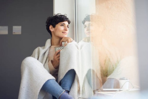 relaxed woman at home sitting at the window - home decoration stock pictures, royalty-free photos & images