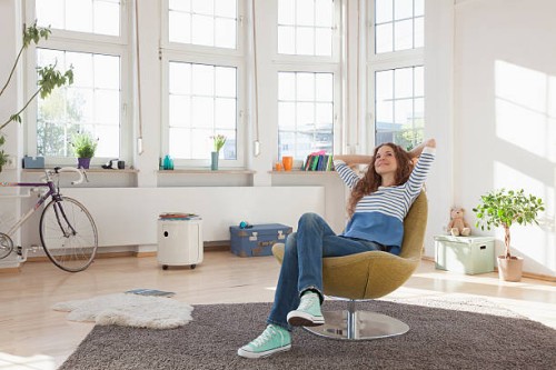 relaxed woman at home sitting in chair - home decoration stock pictures, royalty-free photos & images