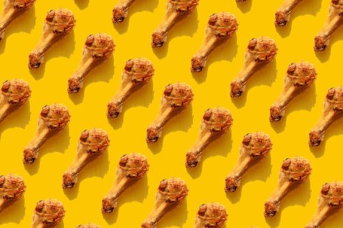 repeated fried chicken legs on the yellow background - junk food stock pictures, royalty-free photos & images