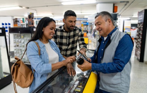 retail clerk helping a couple shopping at a hardware store - home decoration stock pictures, royalty-free photos & images