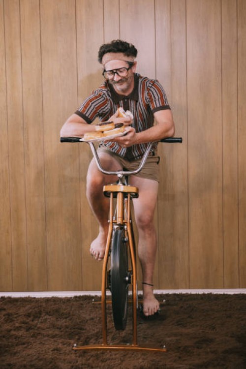 retro nineteen eighties aesthetic exercise bike man with donuts - junk food stock pictures, royalty-free photos & images