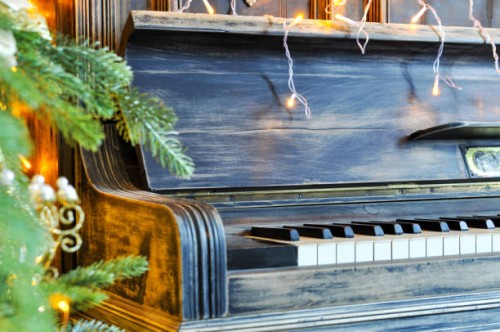 richly decorated for christmas with red and gold ornaments and lights on the background of an old piano. elegant card. closeup. copy spase - concert stock pictures, royalty-free photos & images