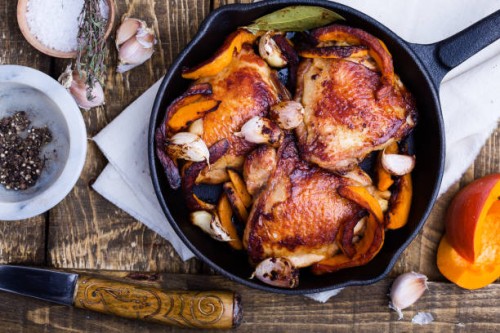 roast chicken legs with pumpkin in cast iron skillet - food stock pictures, royalty-free photos & images