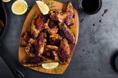 roast chicken wings on cutting board - junk food stock pictures, royalty-free photos & images