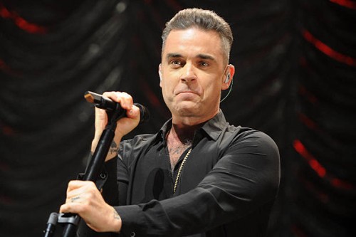 Robbie Williams performs on stage at Key 103 Christmas Live at Manchester Arena on December 9, 2016 in Manchester, England.