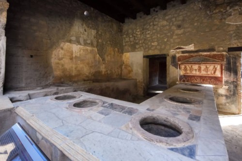 roman restaurant aka "thermopolium" (roman restaurant, inn or food and drink stall) in pompei, campania, italy, a unesco heritage site - junk food stock pictures, royalty-free photos & images