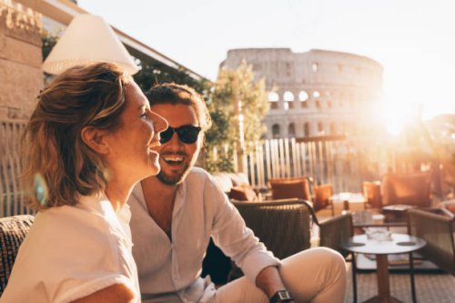 romantic couple having fun at sunset in rome, italy. colosseum and sunstar - travel stock pictures, royalty-free photos & images