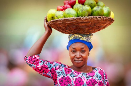rwandan woman carrying basket full of fruits - food stock pictures, royalty-free photos & images