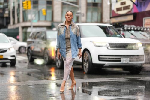 Sai De Silva wears silver earrings, dark plaid pattern collar shirt, light blue pattern/print oversized unbuttoned pattern/print long sleeve shirt,...