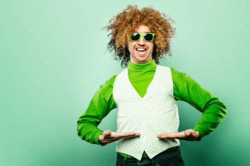 saint patrick's day man celebrating with shamrock vest - fashion stock pictures, royalty-free photos & images