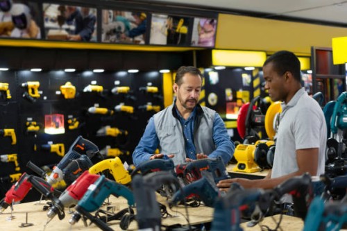 salesman helping a man buying tools at a hardware store - home decoration stock pictures, royalty-free photos & images
