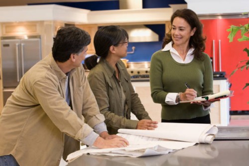 saleswoman helping customers in kitchen showroom - home decoration stock pictures, royalty-free photos & images