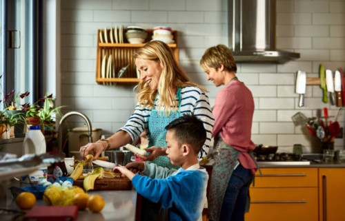 same sex couple cooking with son in kitchen - food stock pictures, royalty-free photos & images