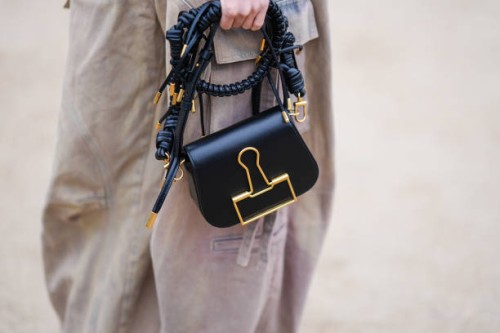 Sandara Park wears beige cargo / jeans, a black and gold leather bag, outside Off-White, during the Womenswear Fall/Winter 2024/2025 as part of Paris...