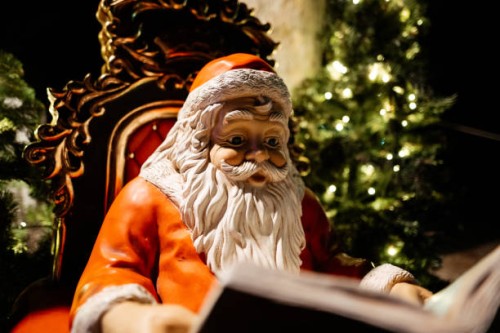 santa claus statue reading a book - garden decoration stock pictures, royalty-free photos & images