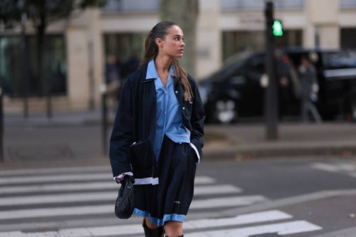 Sarah Lysander Svendby Carter is seen wearing a complete outfit from Miu Miu, consisting of a dark blue cardigan with collar featuring unfinished...