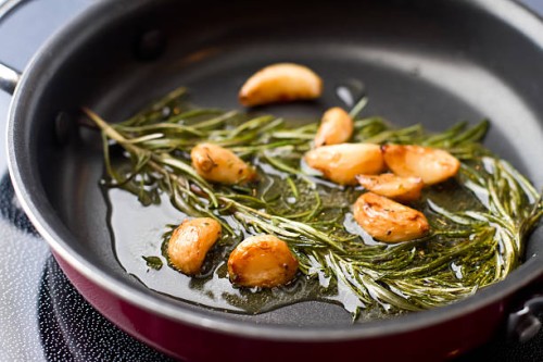 sauteed garlic and rosemary in olive oil - food stock pictures, royalty-free photos & images
