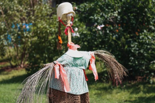 scarecrow protecting garden on sunny summer day - garden decoration stock pictures, royalty-free photos & images