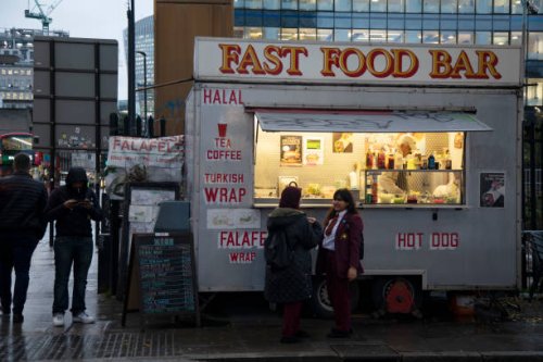 School children waiting outside a fast food bar at Aldgate on 26th November 2019 in London, England, United Kingdom. Eating fast food has been linked...