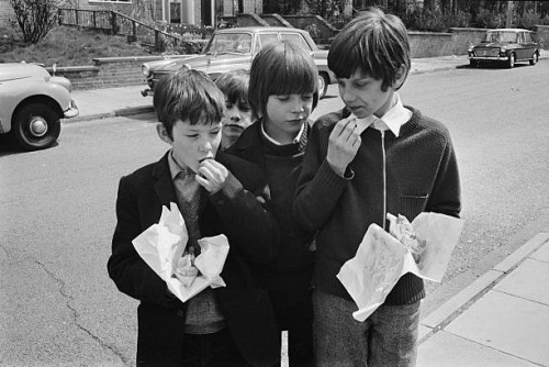 Schoolchildren eating chips because school meals are not being served due to a pay dispute, UK, 28th April 1971.