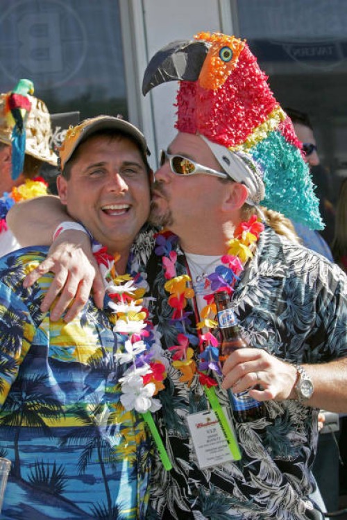 Scott Vincent, of Portsmouth NH gives a peck on the cheak to Kevin St. Pierre, of Natick, prior to the Jimmy Buffet Concert at Fenway Park, 9/12/04.