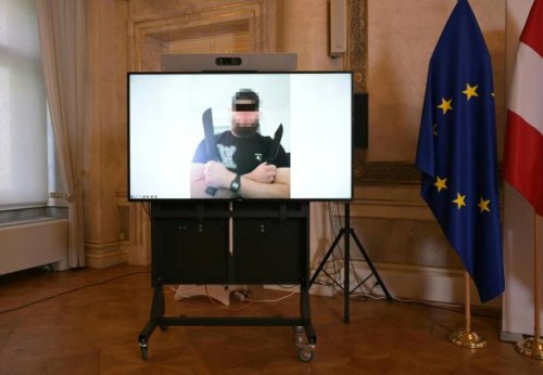 Screen displays a photo of a man arrested in connection with an Islamist attack plot that caused the cancellation of the Vienna leg of a tour by...