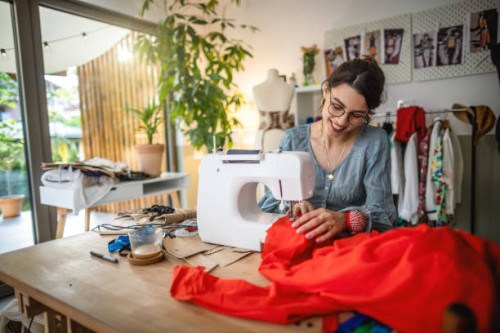 seamstress working on sewing machine - fashion stock pictures, royalty-free photos & images