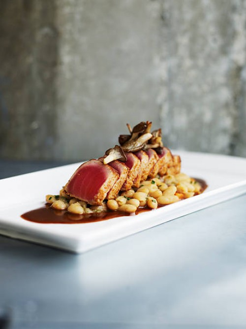 seared spiced tuna with cannellini beans - food stock pictures, royalty-free photos & images