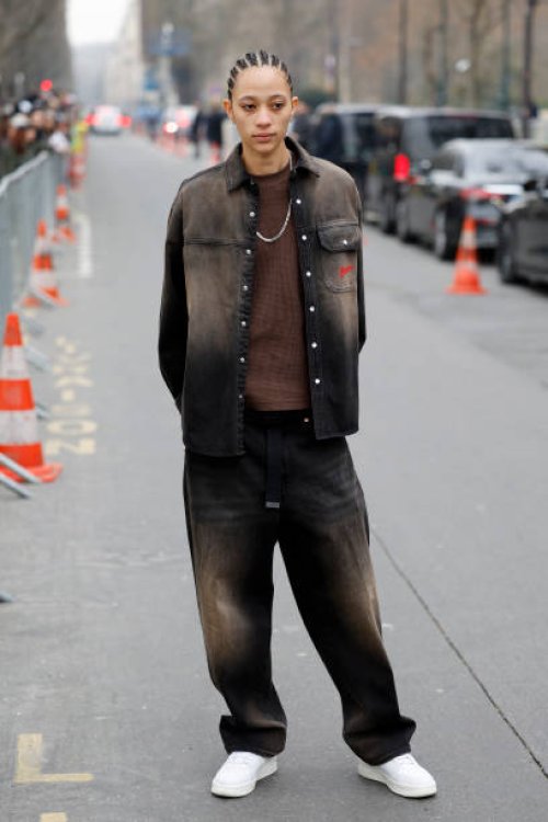 Selena Forrest wears brown faded denim jacket with matching jeans, brown t-shirt, white Nike sneakers, outside Chanel, during the Womenswear...