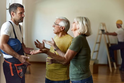 senior couple arguing with manual worker during renovation process at home. - home decoration stock pictures, royalty-free photos & images