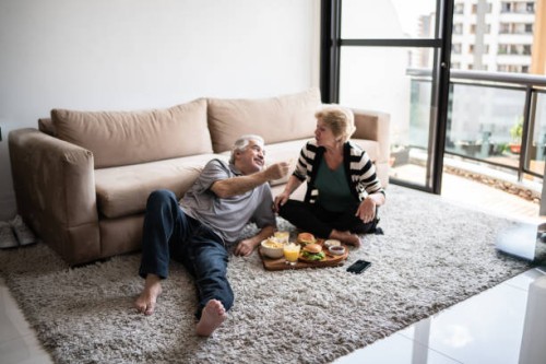 senior couple having a picnic at home - junk food stock pictures, royalty-free photos & images