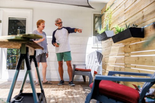 senior couple looking at planters in back yard - home decoration stock pictures, royalty-free photos & images