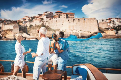 senior couple on a sailing cruise looking at coastline. - travel stock pictures, royalty-free photos & images