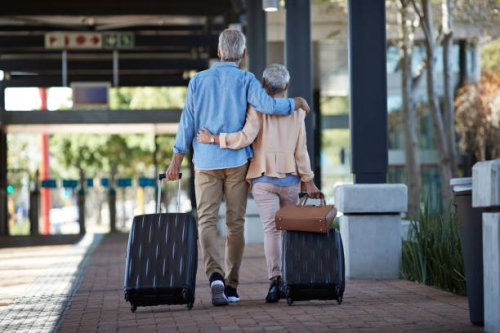 senior couple walking together on public transport station - travel stock pictures, royalty-free photos & images