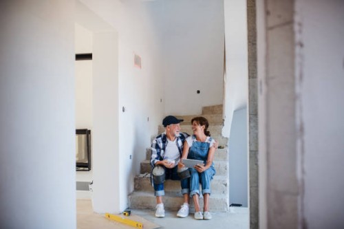 senior couple with tablet laying tile floor in new home. - home decoration stock pictures, royalty-free photos & images