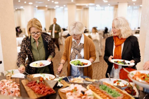 senior friends enjoying breakfast buffet at the hotel or restaurant - food stock pictures, royalty-free photos & images