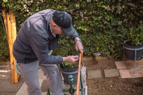 senior making a flower holder and a table in one - garden decoration stock pictures, royalty-free photos & images