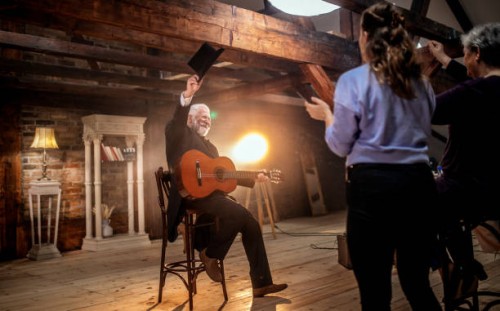 senior male guitarist on the stage of theatre - concert stock pictures, royalty-free photos & images