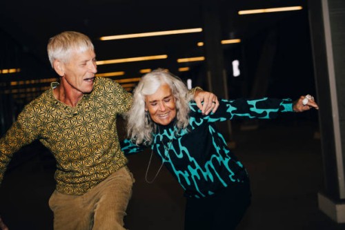 senior man and woman dancing in parking garage - fashion stock pictures, royalty-free photos & images