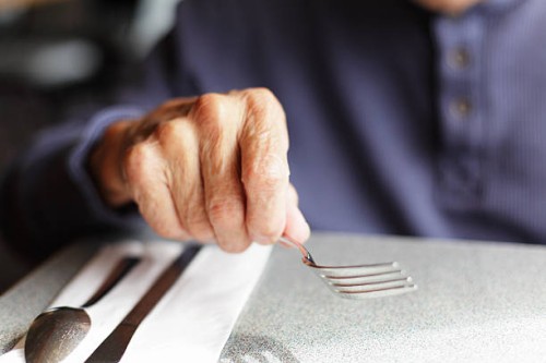 senior man holding fork at restaurant table - food stock pictures, royalty-free photos & images