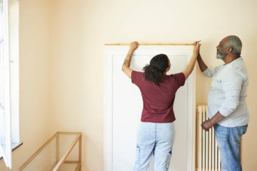 senior man renovating home with daughter - home decoration stock pictures, royalty-free photos & images