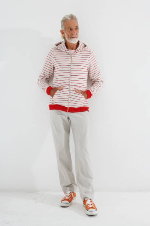 senior man wearing hooded top standing, hands in pockets - fashion stock pictures, royalty-free photos & images