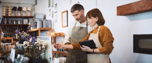 senior white couple work together at own small business retail shop. discuss talk using digital tablet, computer. sell art and craft home decor product. adult business people, sme entrepreneur concept - home decoration stock 