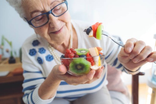 senior woman at home - food stockfoto's en -beelden